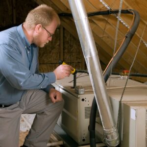 Man inspecting his attics ventilation 