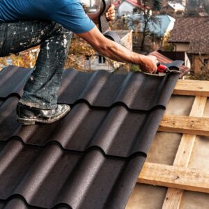 Roofer installing roofing materials
