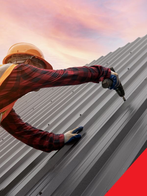 roofer working on metal commercial roof