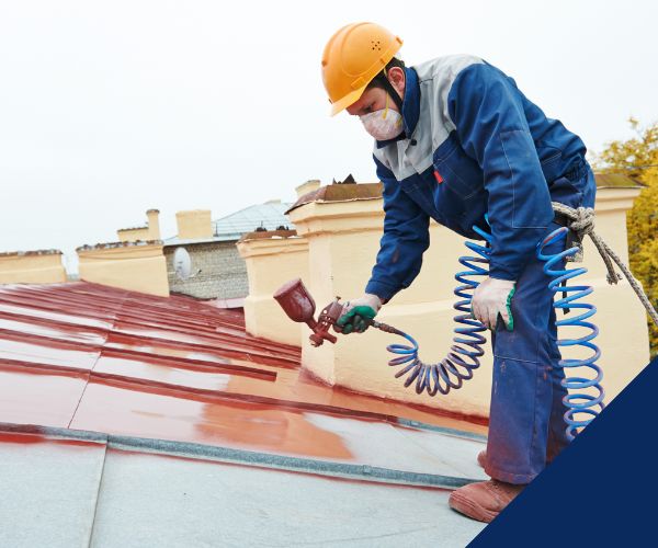 roof paint coating being applied to metal roof